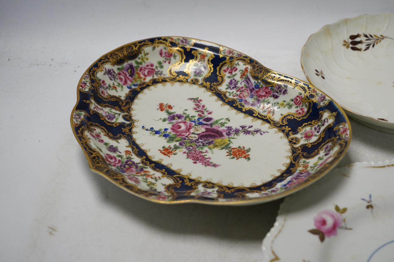 An 18th century Worcester dessert dish and two later Barr Flight & Barr plates, larger 26cm. Condition - worn